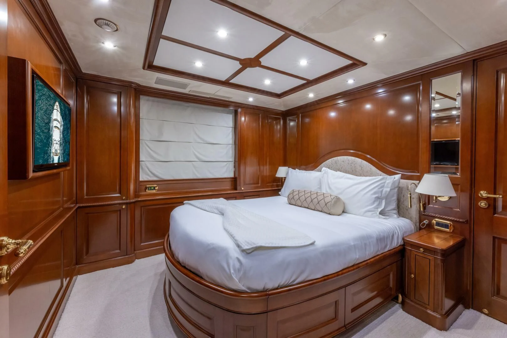 a room with a bed and a mirror aboard NAMASTE Yacht for Sale