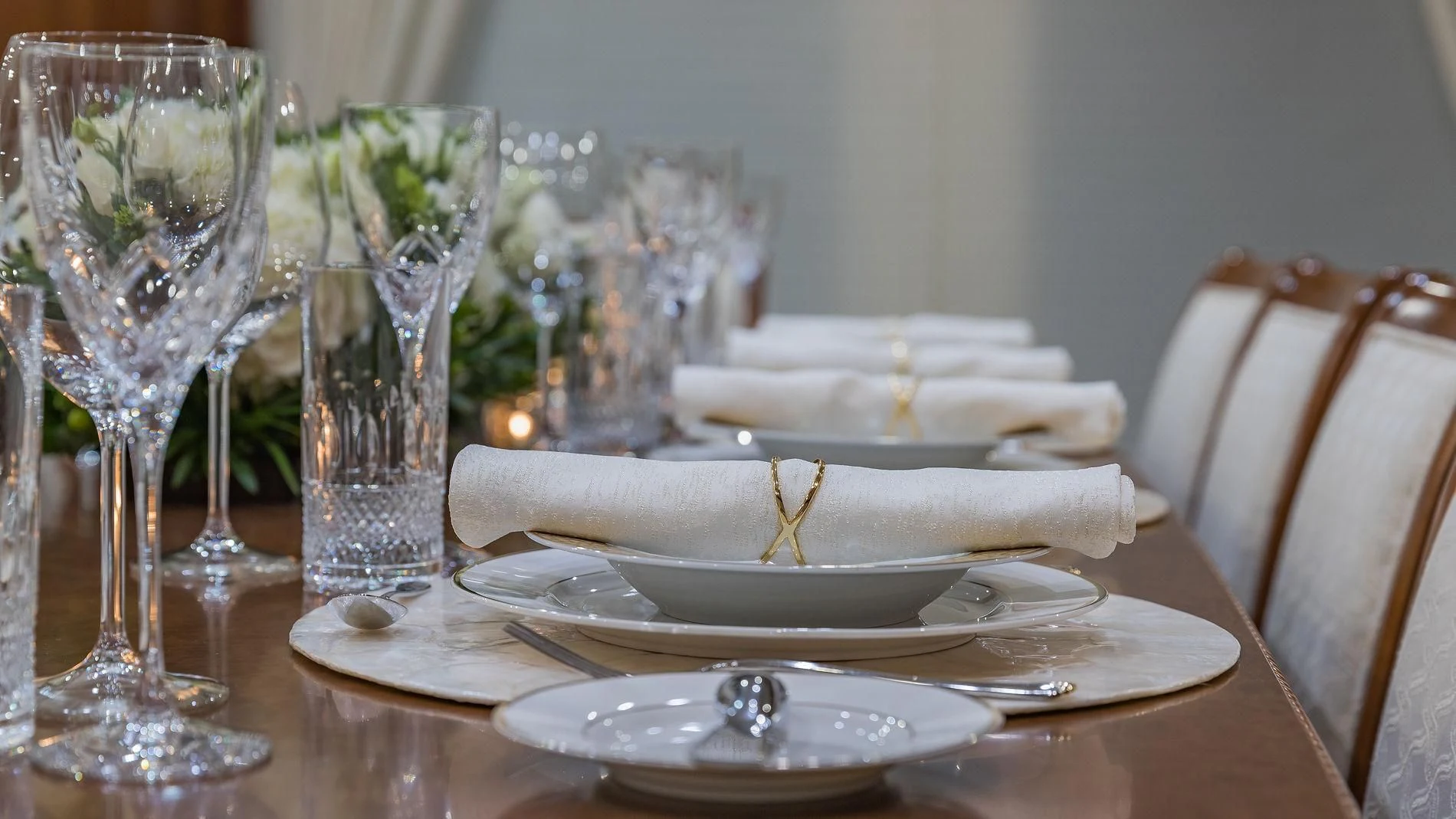 a table with a plate of food and glasses on it aboard NAMASTE Yacht for Sale