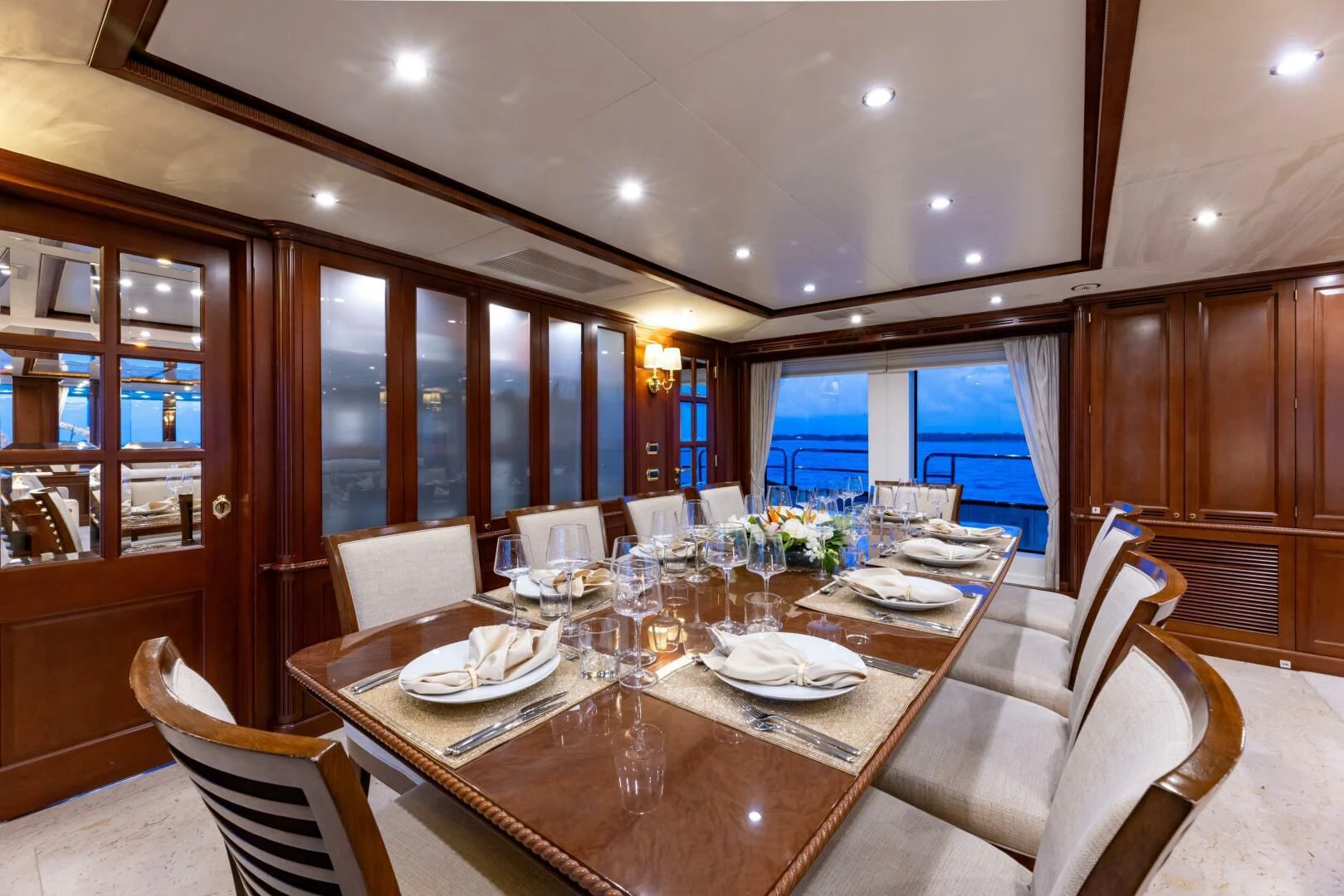 a dining room with a table set aboard NAMASTE Yacht for Sale