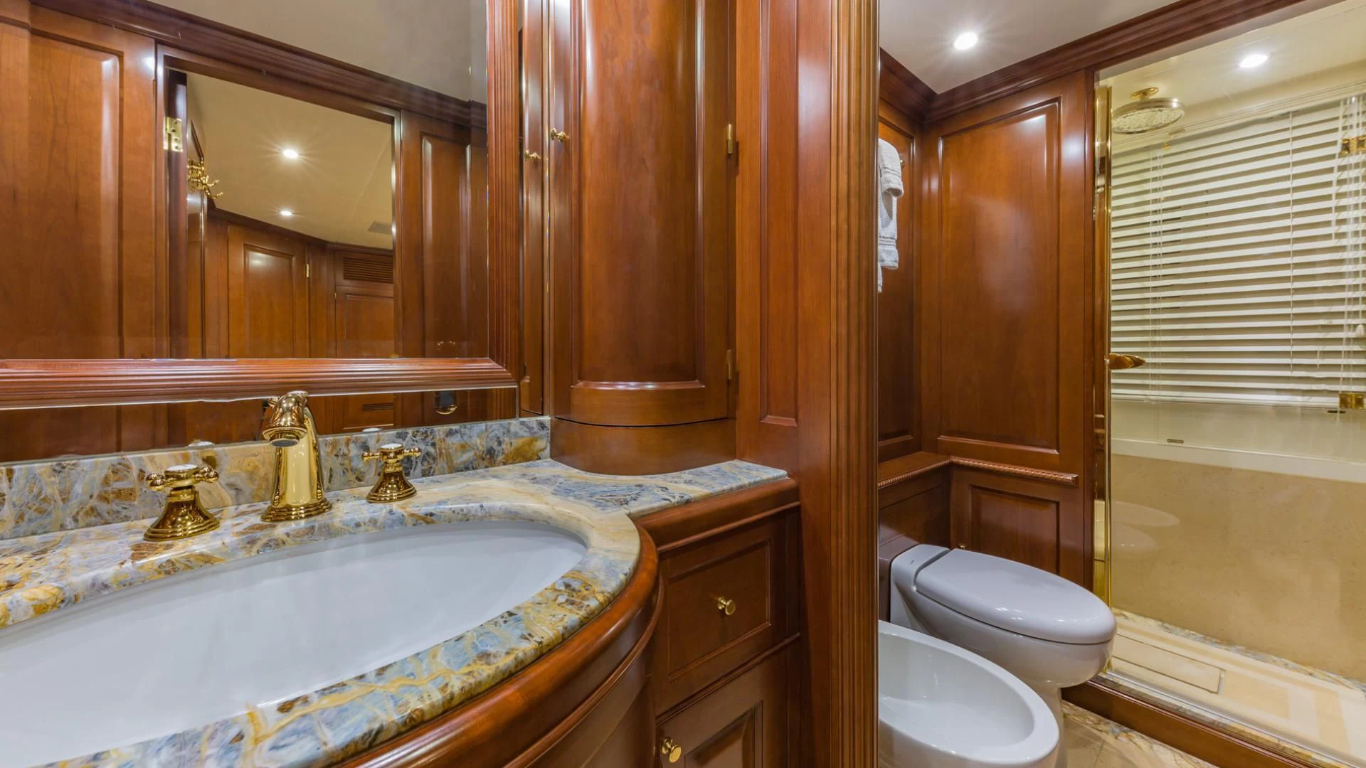 a bathroom with a tub sink and toilet aboard NAMASTE Yacht for Sale