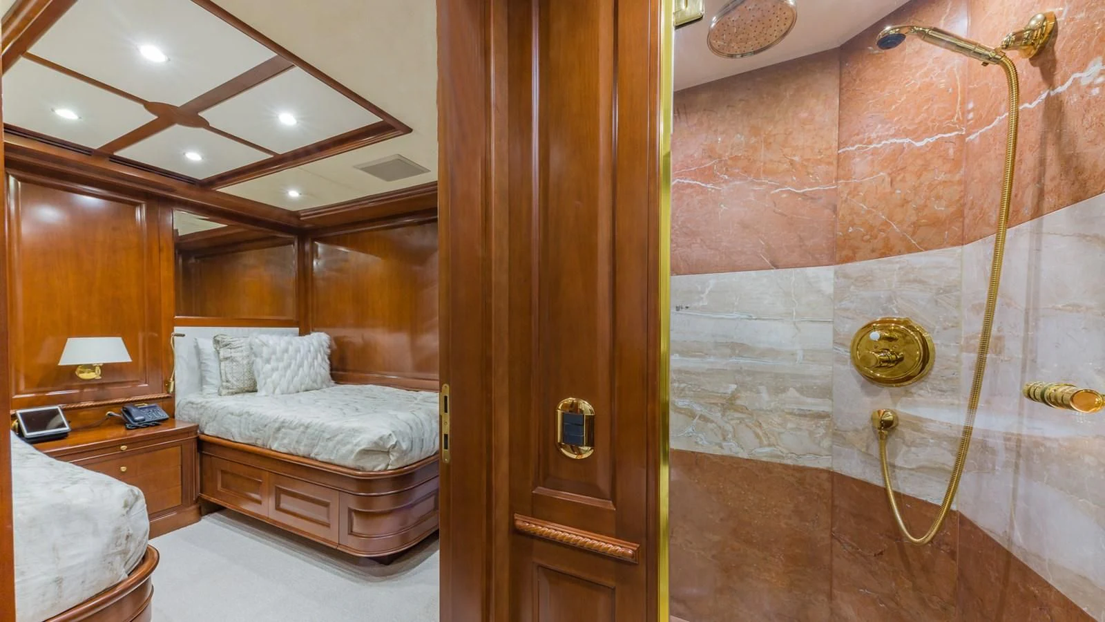 a bedroom with a wood door aboard NAMASTE Yacht for Sale