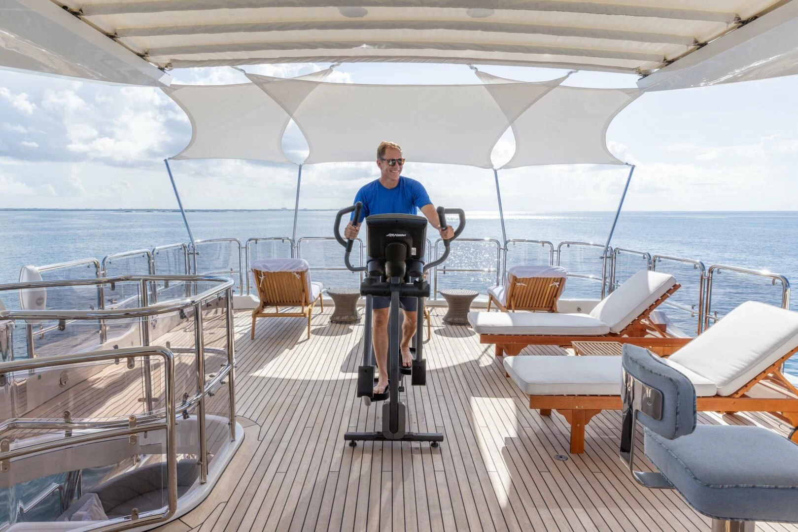 a person standing on a deck with a camera on a tripod aboard NAMASTE Yacht for Sale