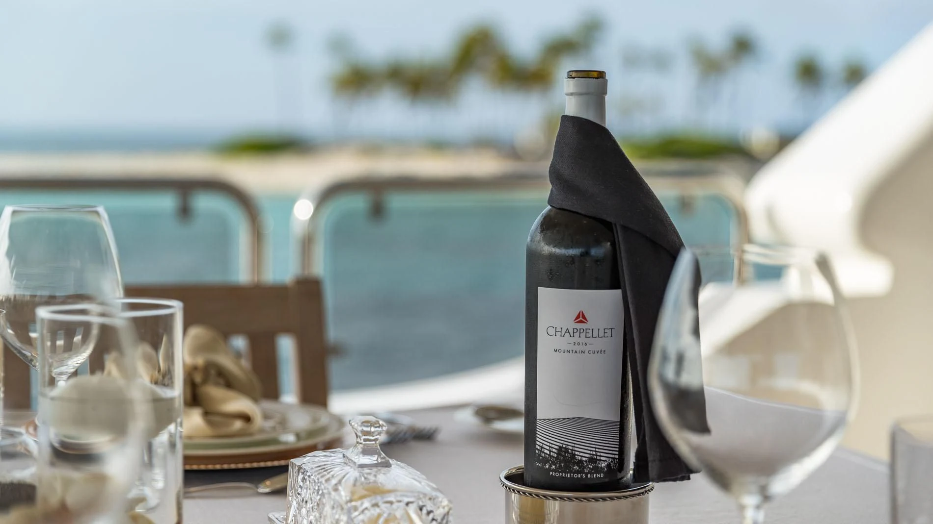 a bottle of wine on a table aboard NAMASTE Yacht for Sale