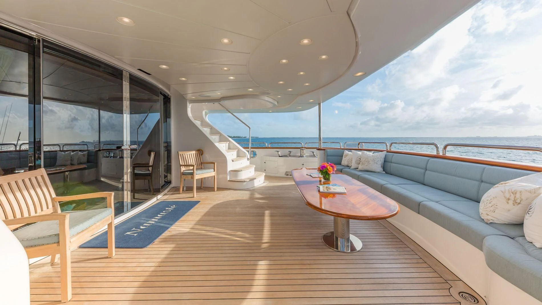a large living room with a large balcony overlooking the ocean aboard NAMASTE Yacht for Sale