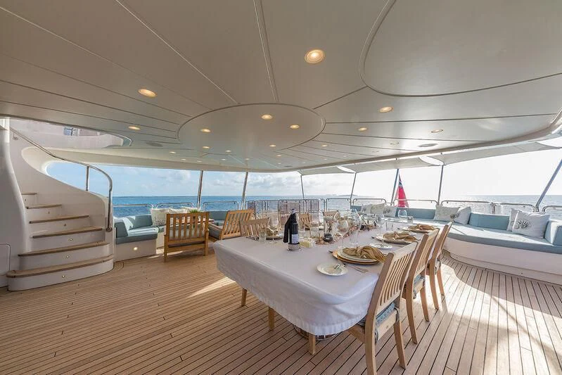 a room with a table and chairs aboard NAMASTE Yacht for Sale