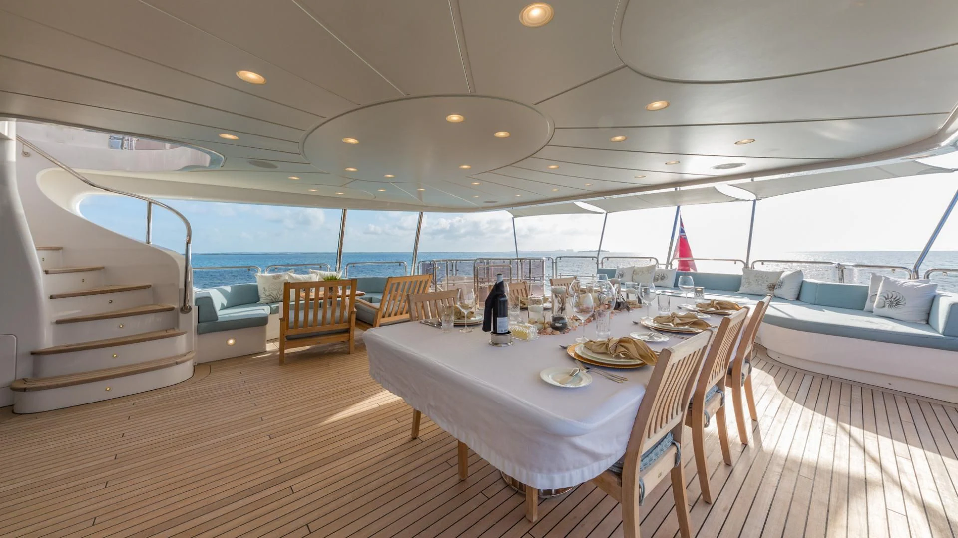 a large room with a table and chairs aboard NAMASTE Yacht for Sale