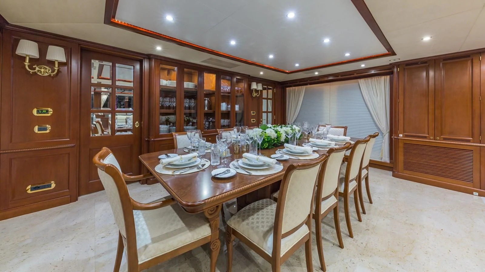 a dining room with a table set aboard NAMASTE Yacht for Sale