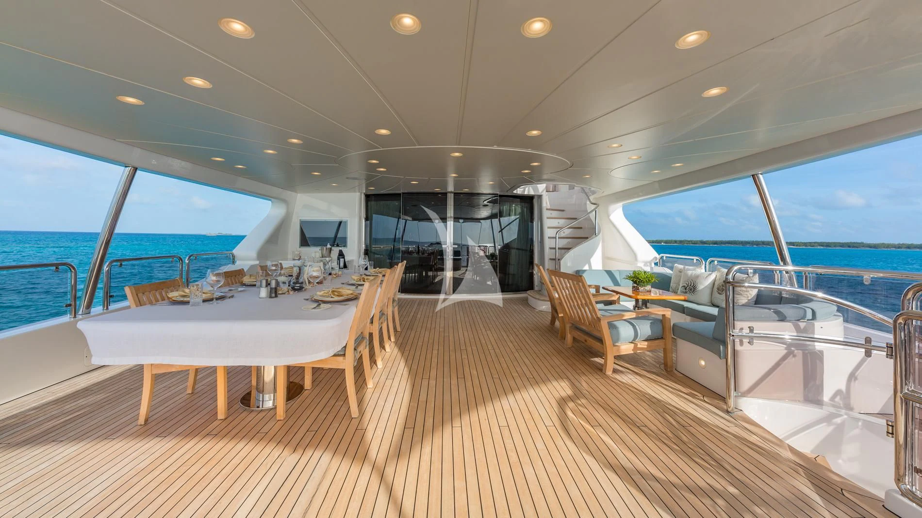 a room with tables and chairs aboard NAMASTE Yacht for Sale