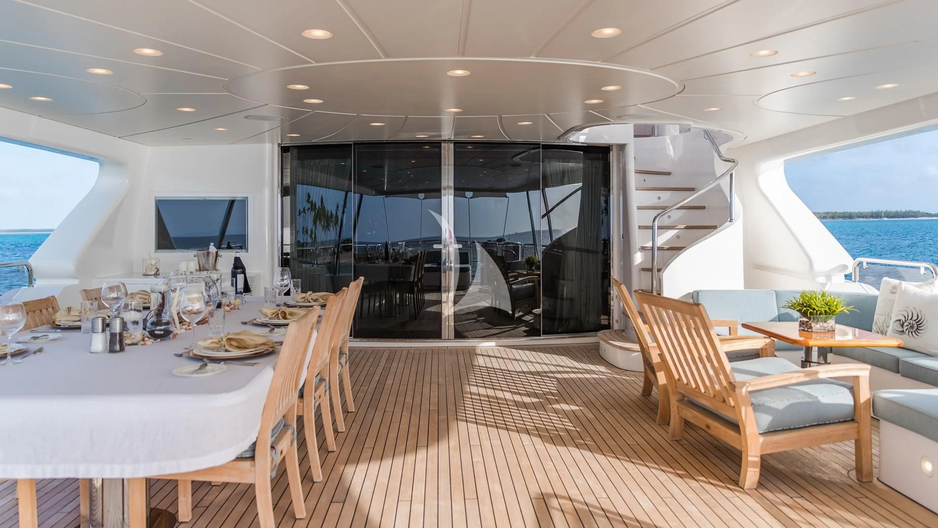 a room with a table chairs and a large window aboard NAMASTE Yacht for Sale