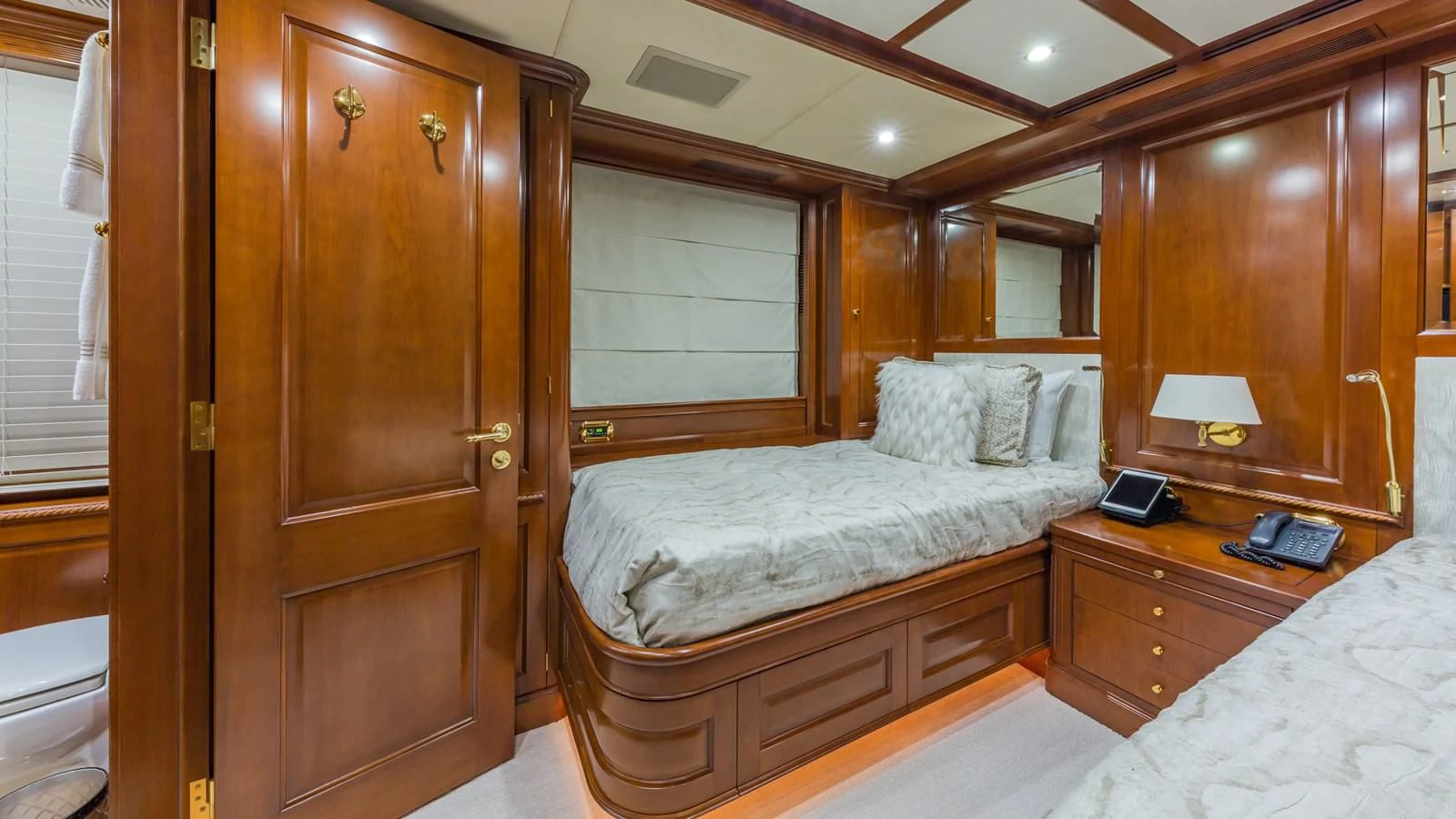 a bedroom with a bed and a closet aboard NAMASTE Yacht for Sale