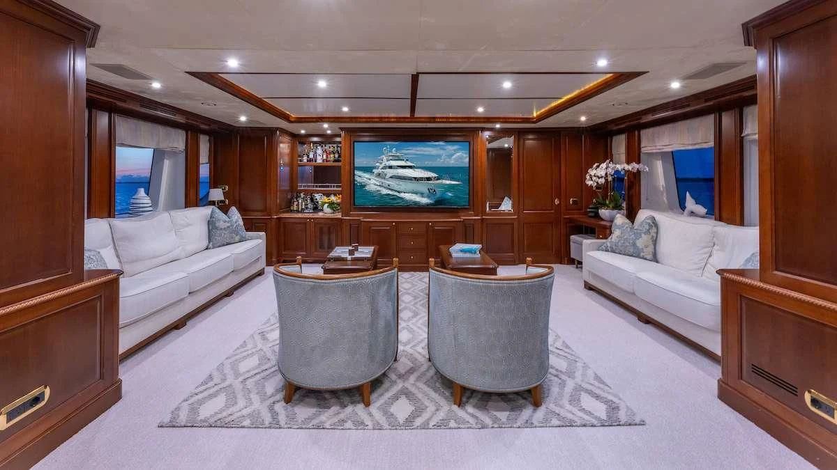 a living room with a large screen aboard NAMASTE Yacht for Sale