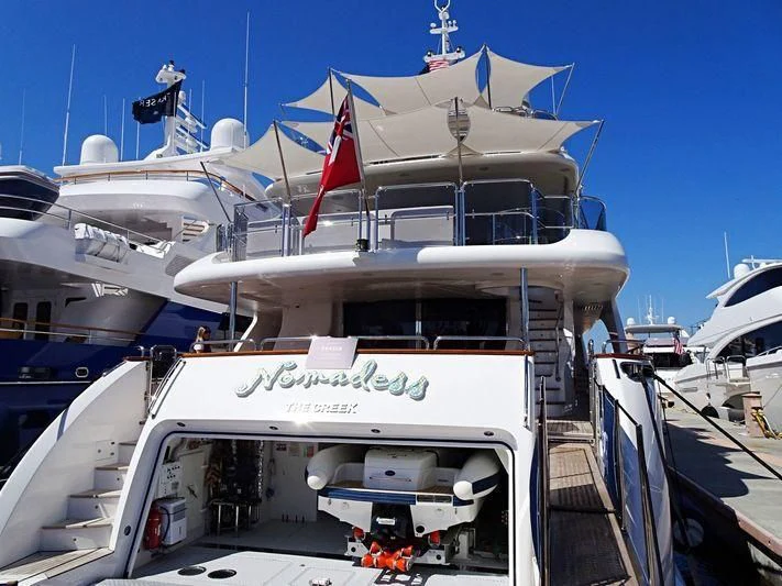 a boat with a flag on the front aboard NAMASTE Yacht for Sale