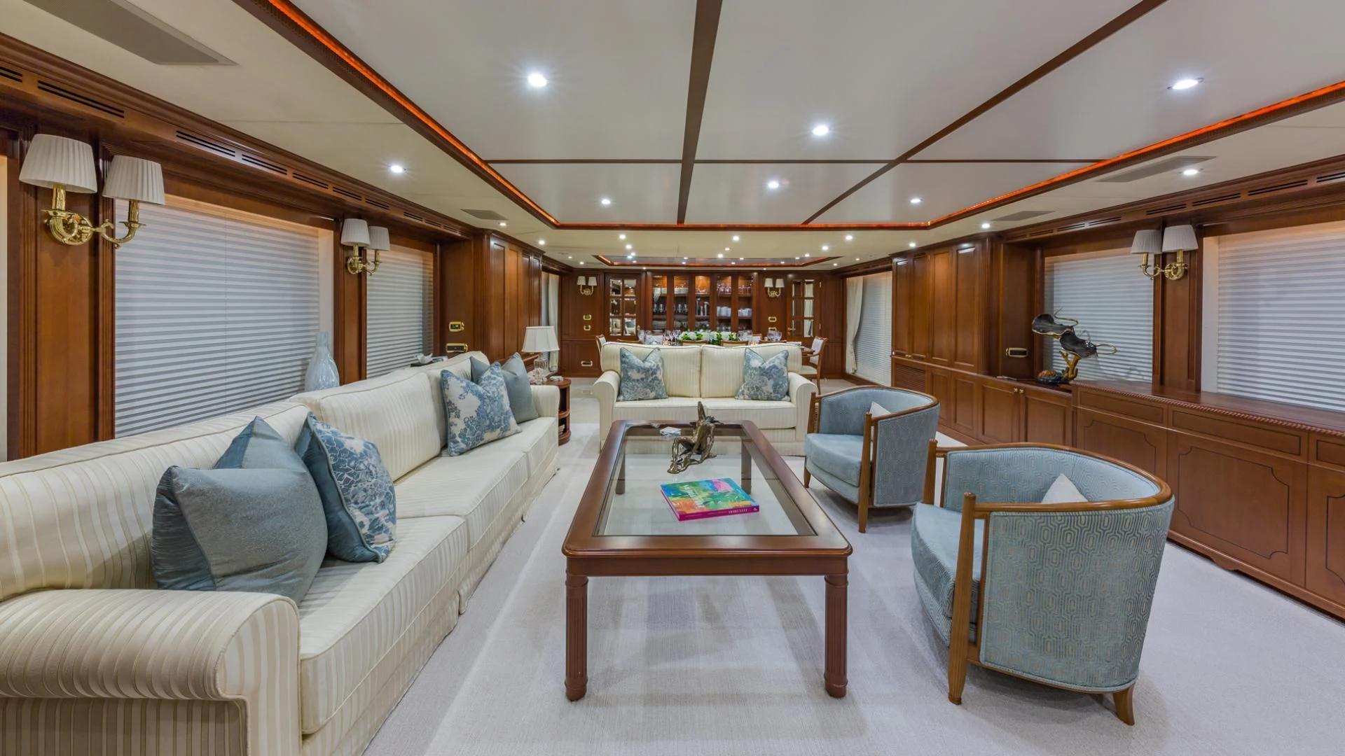 a living room with a couch and a table aboard NAMASTE Yacht for Sale