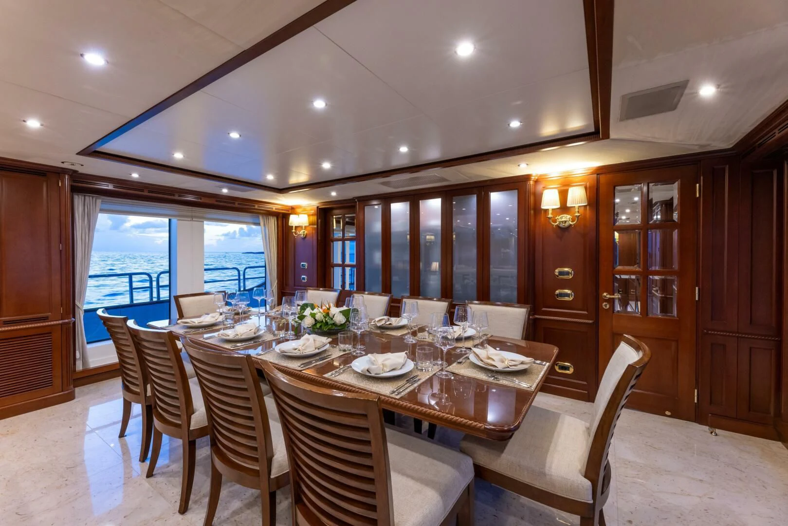 a large dining room with a large table and chairs aboard NAMASTE Yacht for Sale