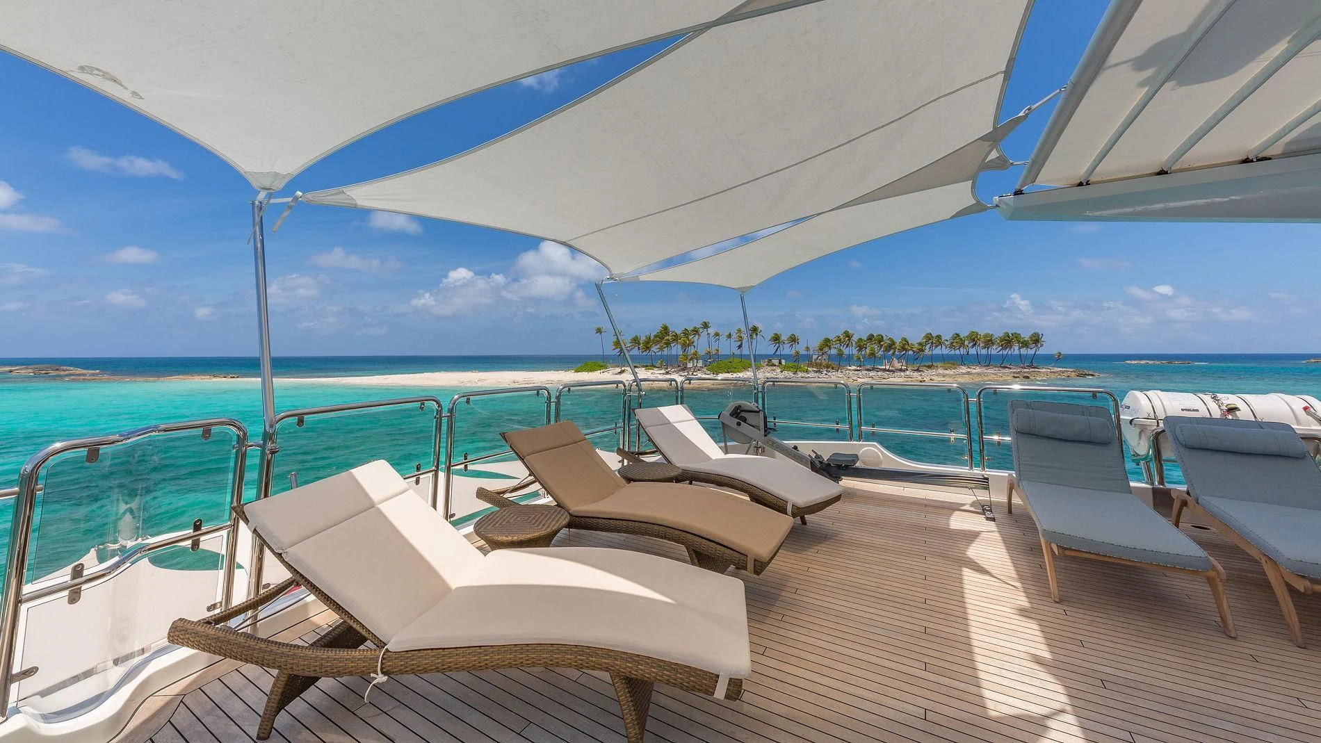 a deck with lounge chairs on it aboard NAMASTE Yacht for Sale