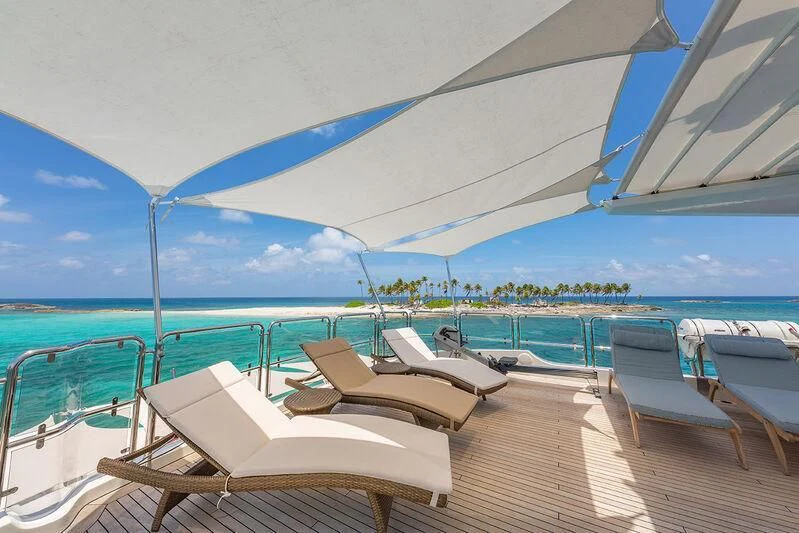 lounge chairs on a deck overlooking the ocean aboard NAMASTE Yacht for Sale