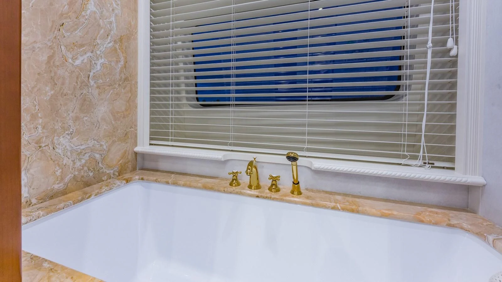 a bathtub with a window aboard NAMASTE Yacht for Sale