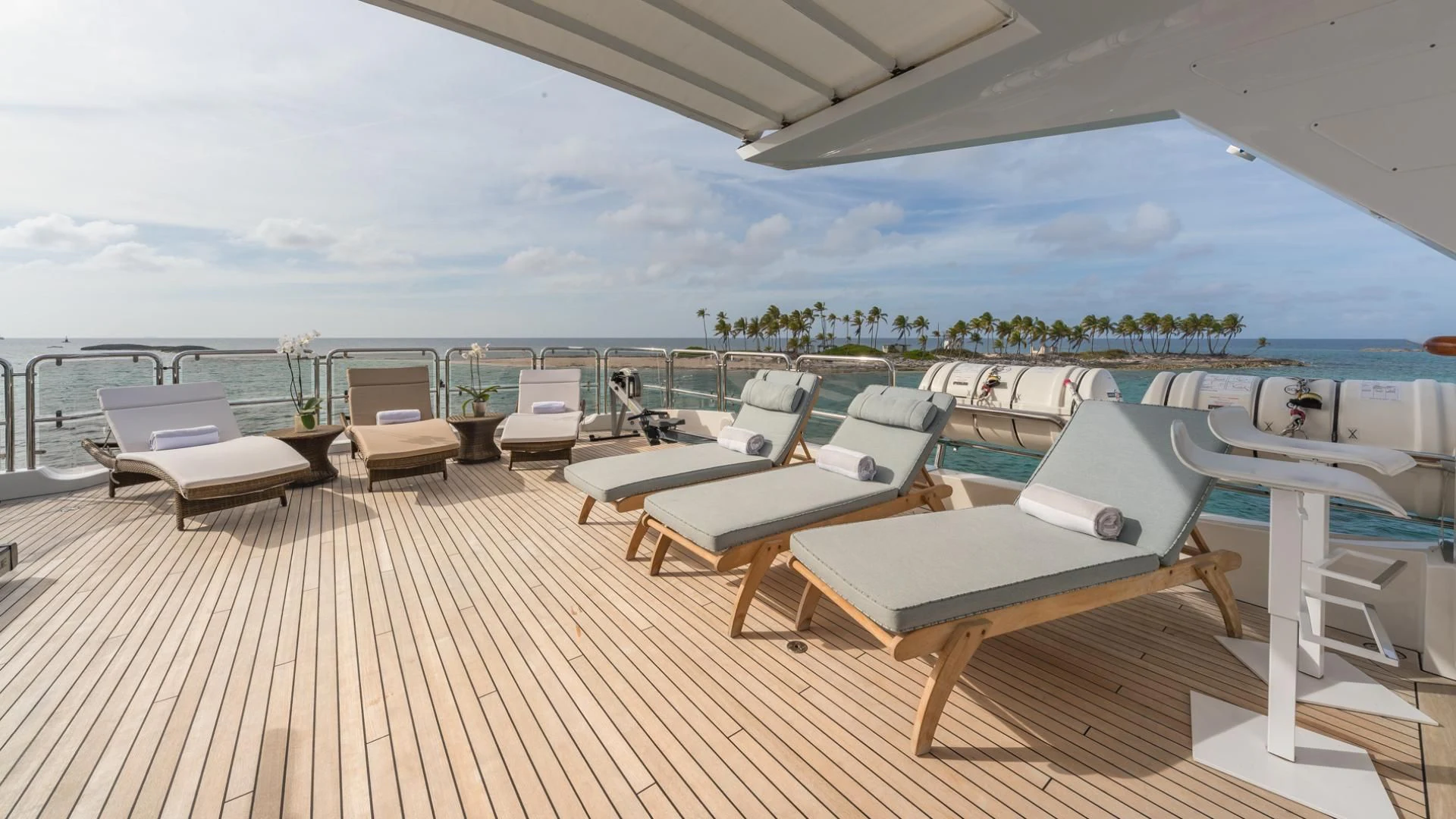 a deck with lounge chairs on it aboard NAMASTE Yacht for Sale