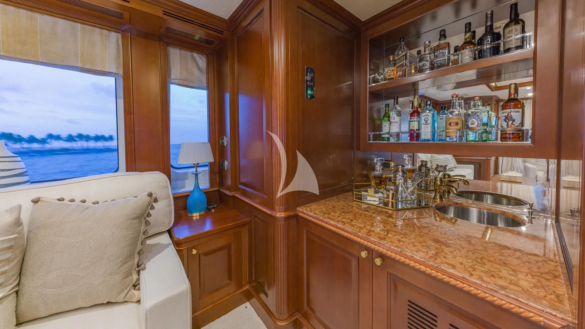 a kitchen with a sink and shelves aboard NAMASTE Yacht for Sale