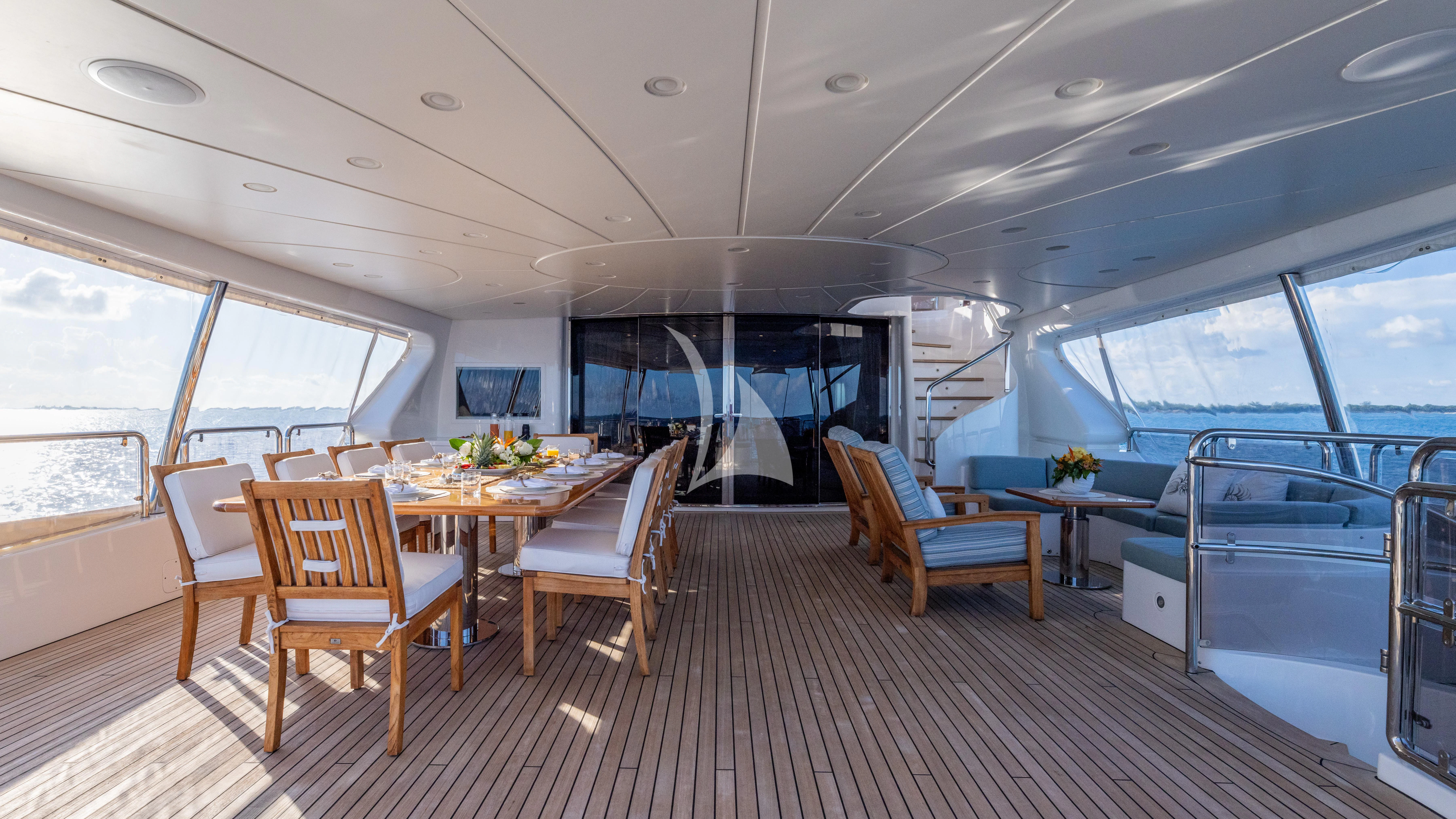 a large room with a table and chairs aboard NAMASTE Yacht for Sale