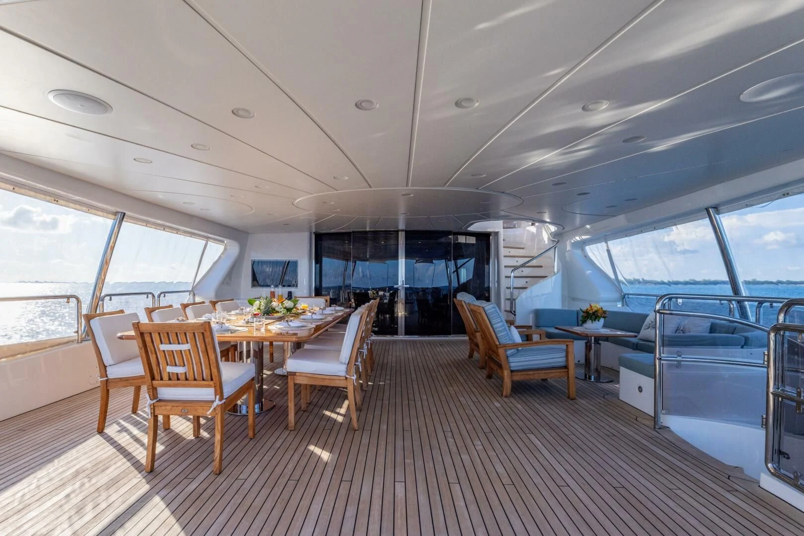 a room with a table chairs and a large window aboard NAMASTE Yacht for Sale