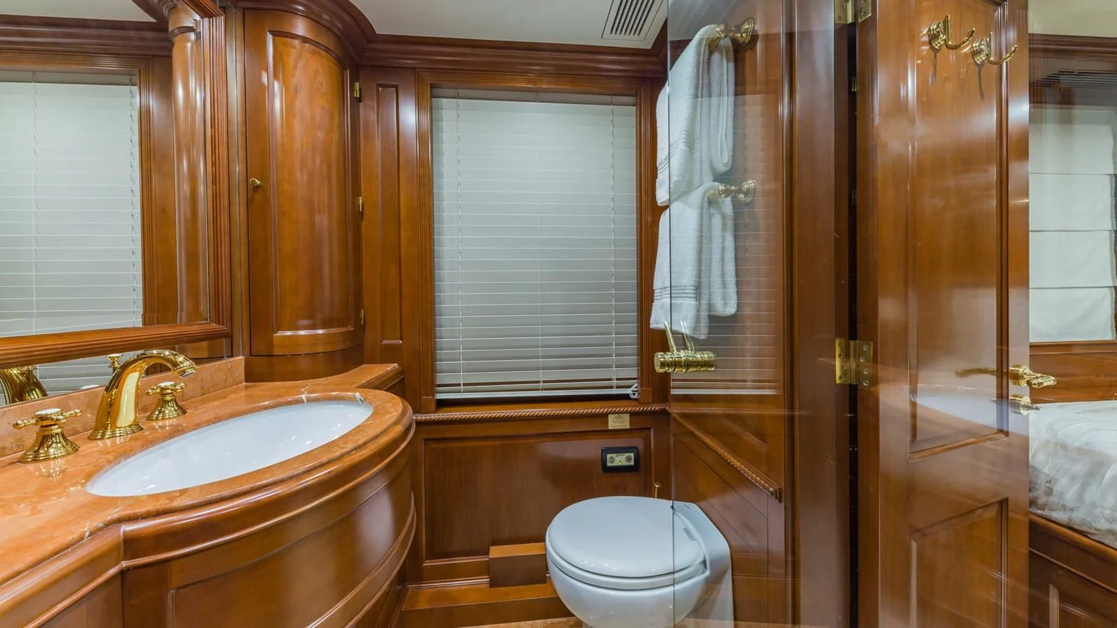 a bathroom with a sink toilet and shower aboard NAMASTE Yacht for Sale