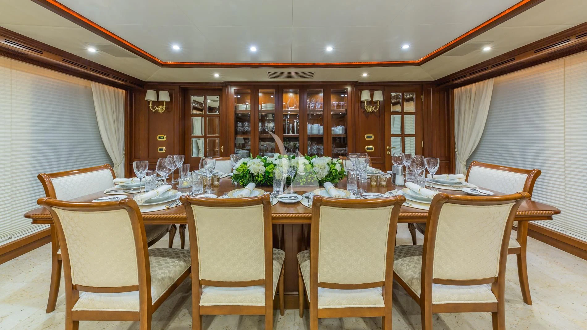 a dining room with a table set aboard NAMASTE Yacht for Sale