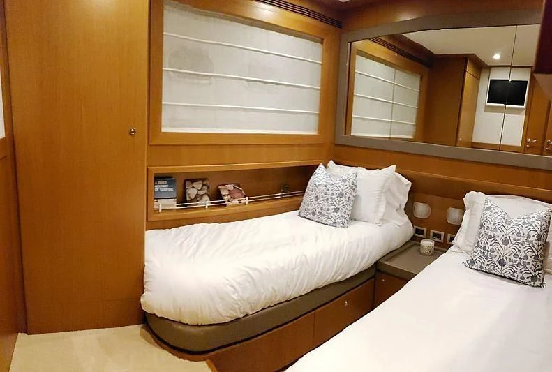 a bed with pillows and a mirror aboard ALL RUMORS Yacht for Sale