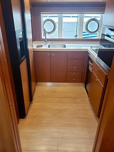a kitchen with a sink and cabinets aboard ALL RUMORS Yacht for Sale