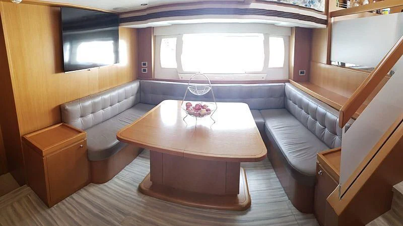 a room with a table and a window aboard ALL RUMORS Yacht for Sale
