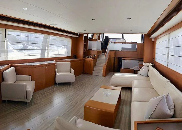 a living room with a staircase and furniture aboard ALL RUMORS Yacht for Sale