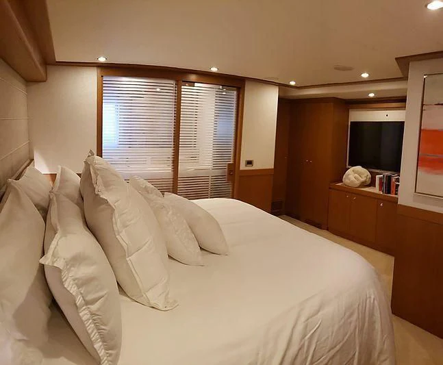 a bed with white sheets aboard ALL RUMORS Yacht for Sale