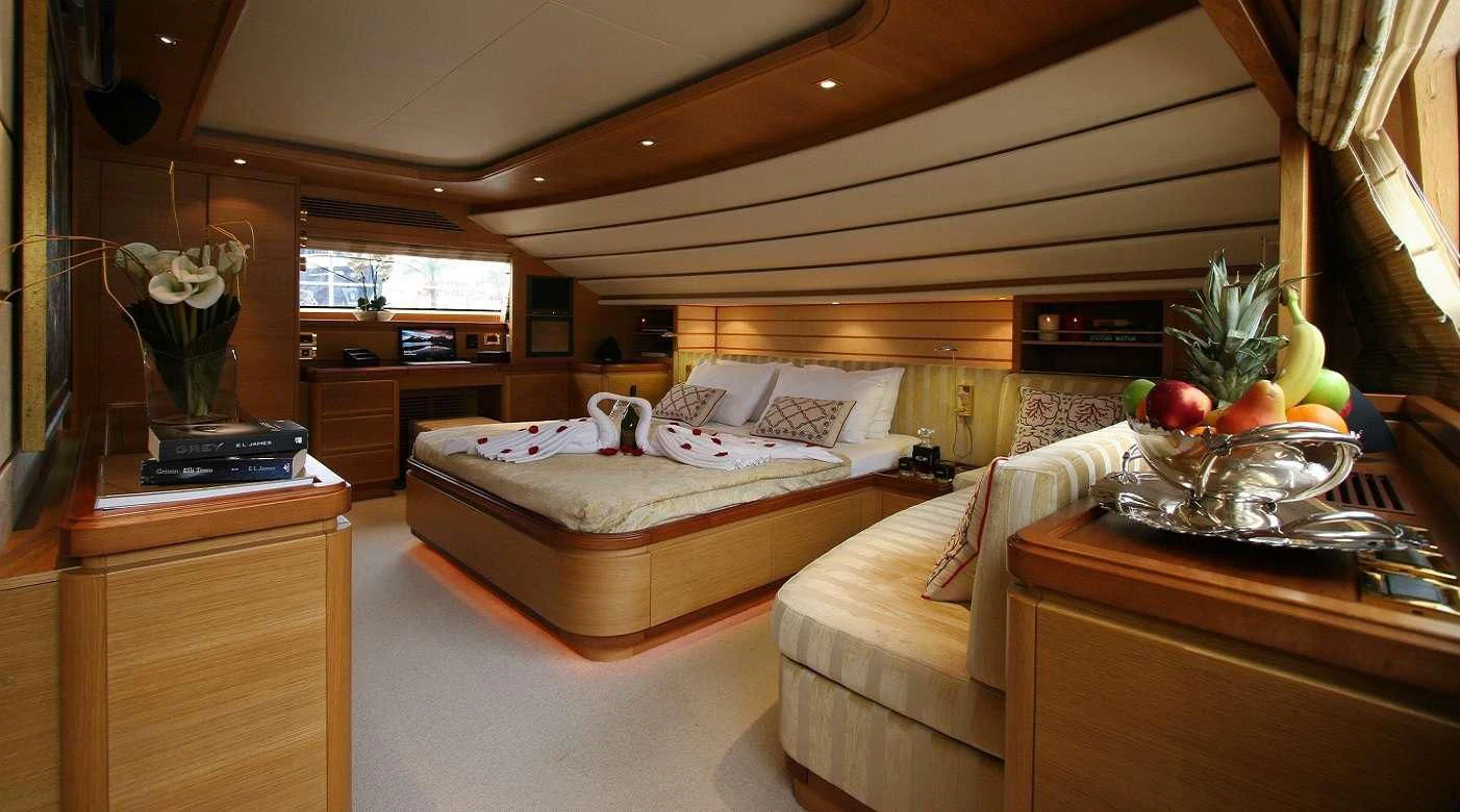 a bedroom with a bed and a desk aboard PAREAKKI Yacht for Sale