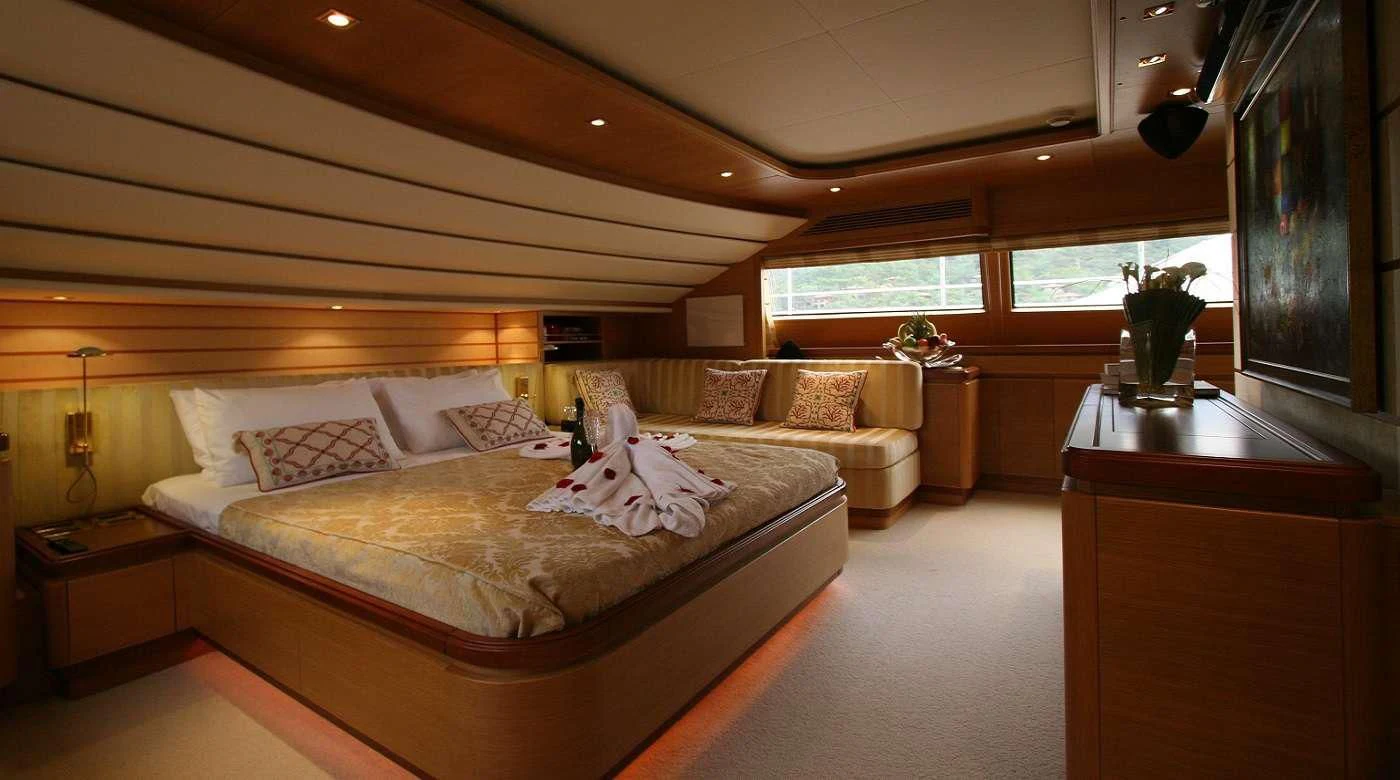 a bedroom with a bed and a desk aboard PAREAKKI Yacht for Sale