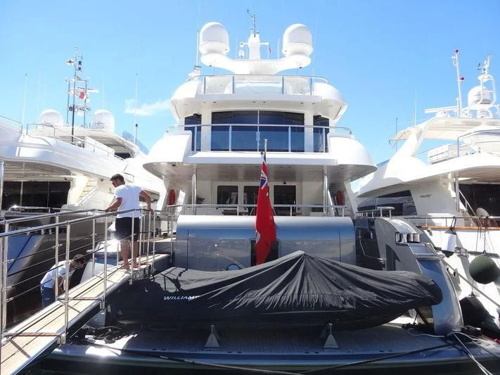 a boat docked with a flag aboard I SEA Yacht for Sale