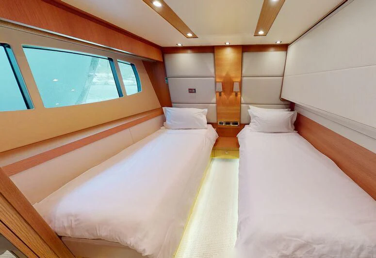 a room with a bed and a window aboard MAKANI II Yacht for Charter