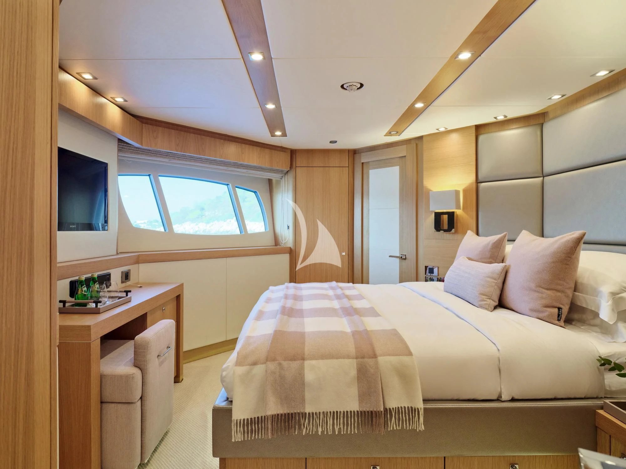a bedroom with a bed and a desk aboard MAKANI II Yacht for Charter