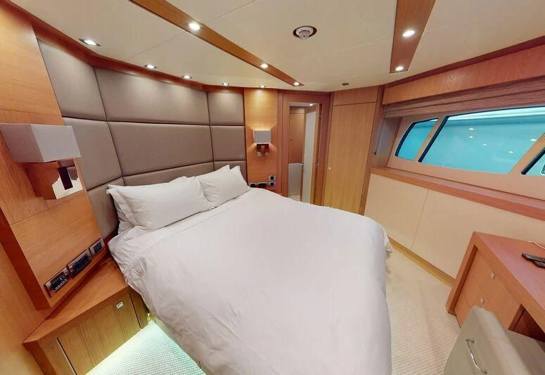 a room with a bed and a window aboard MAKANI II Yacht for Charter