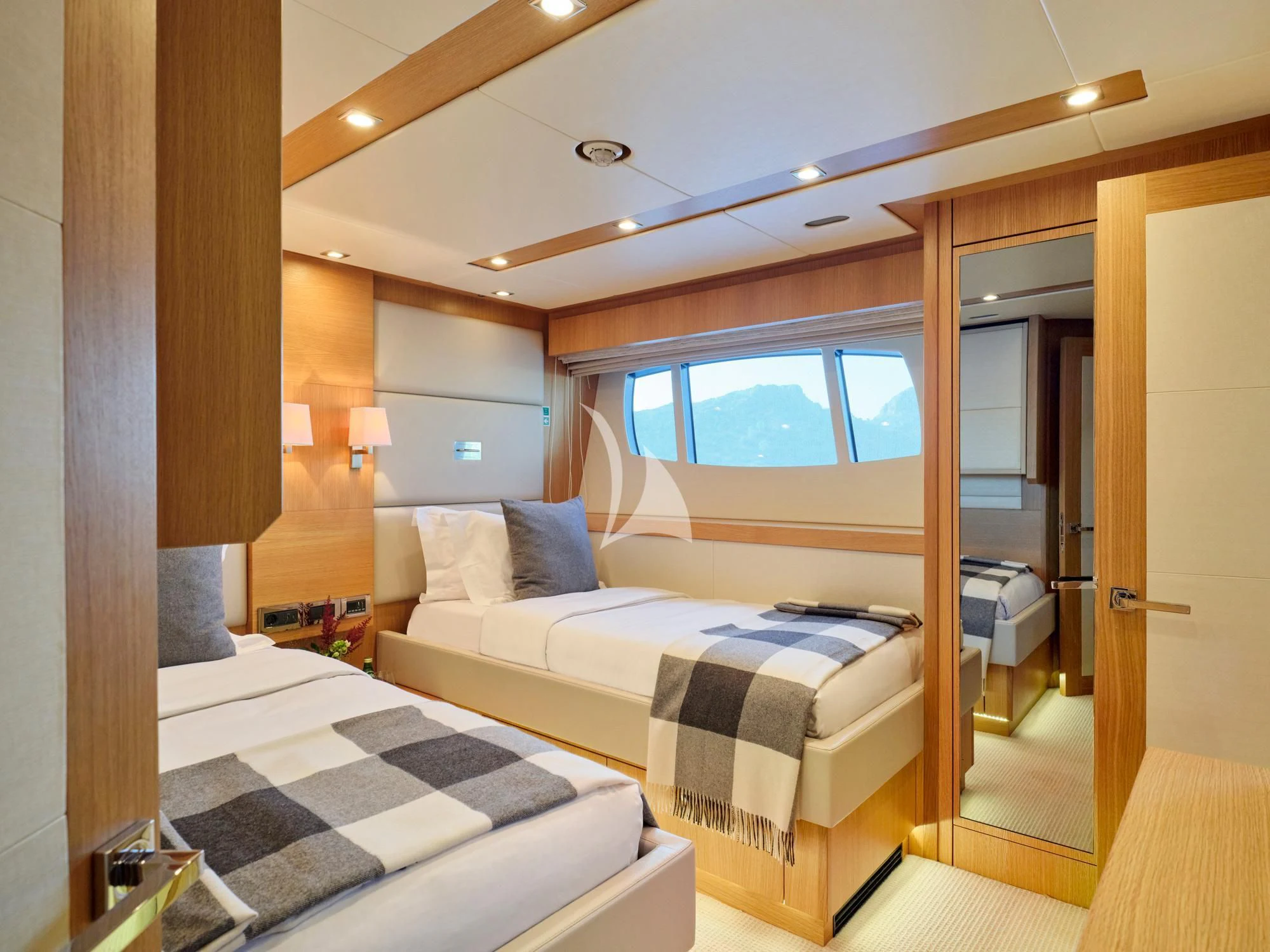 a bedroom with a bed and a window aboard MAKANI II Yacht for Charter