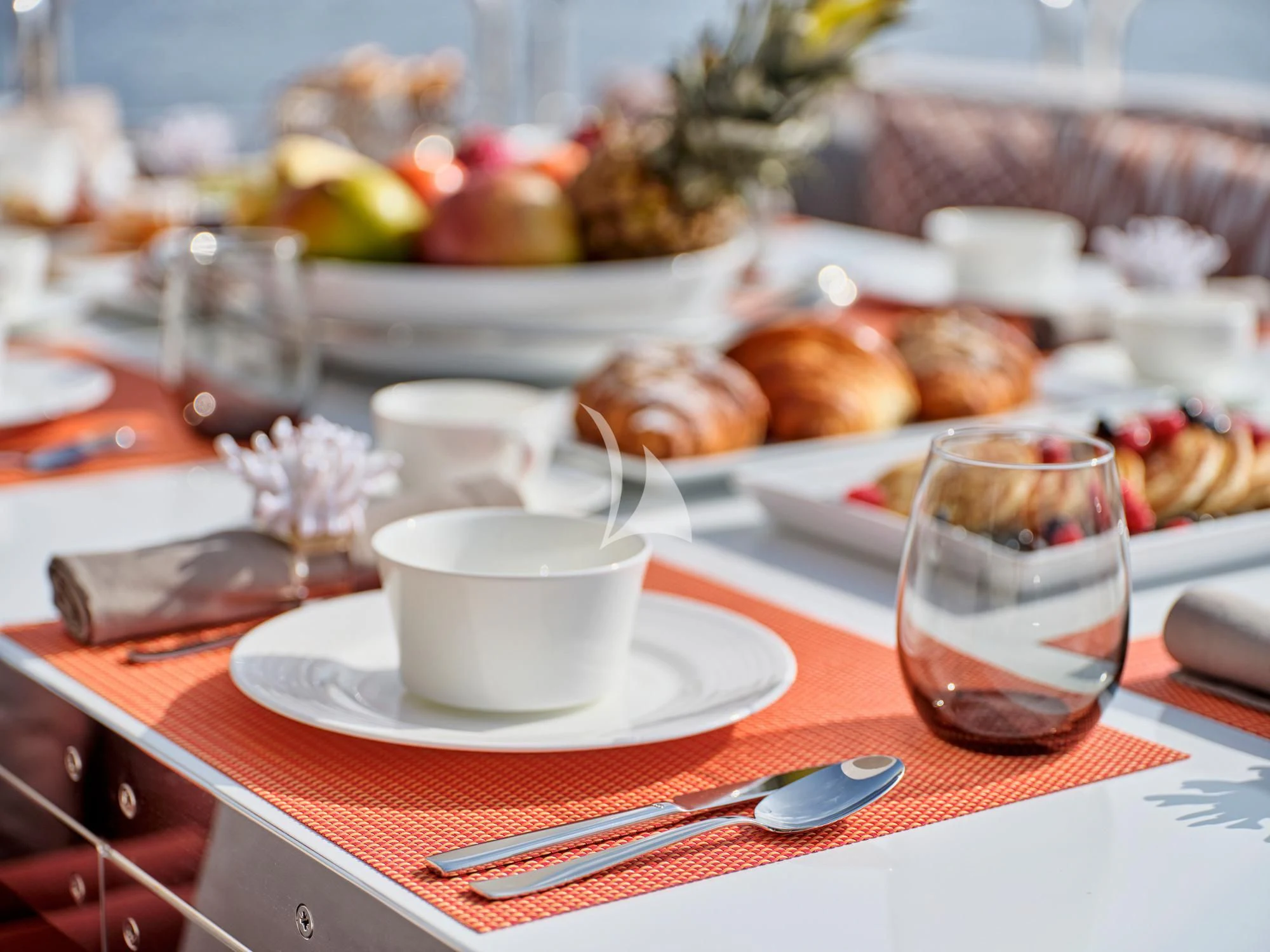 a table with food and drinks aboard MAKANI II Yacht for Charter