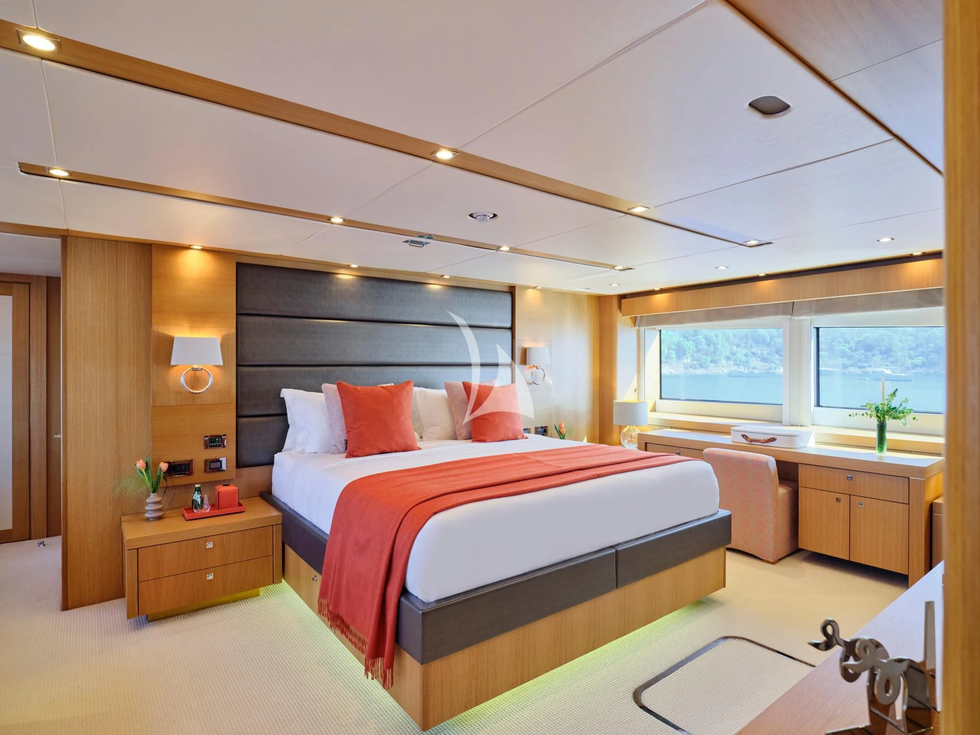a bedroom with a bed and a desk aboard MAKANI II Yacht for Charter