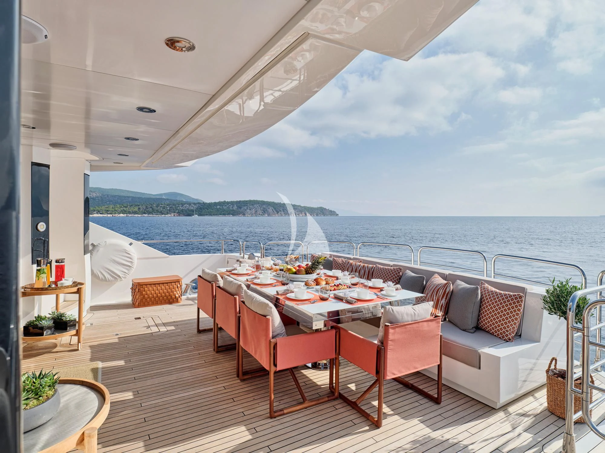 a table and chairs on a deck aboard MAKANI II Yacht for Charter