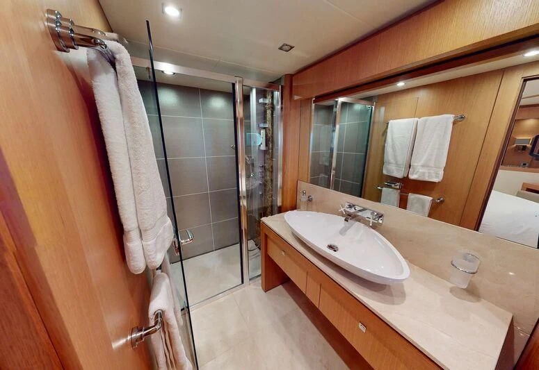 a bathroom with a sink and a mirror aboard MAKANI II Yacht for Charter