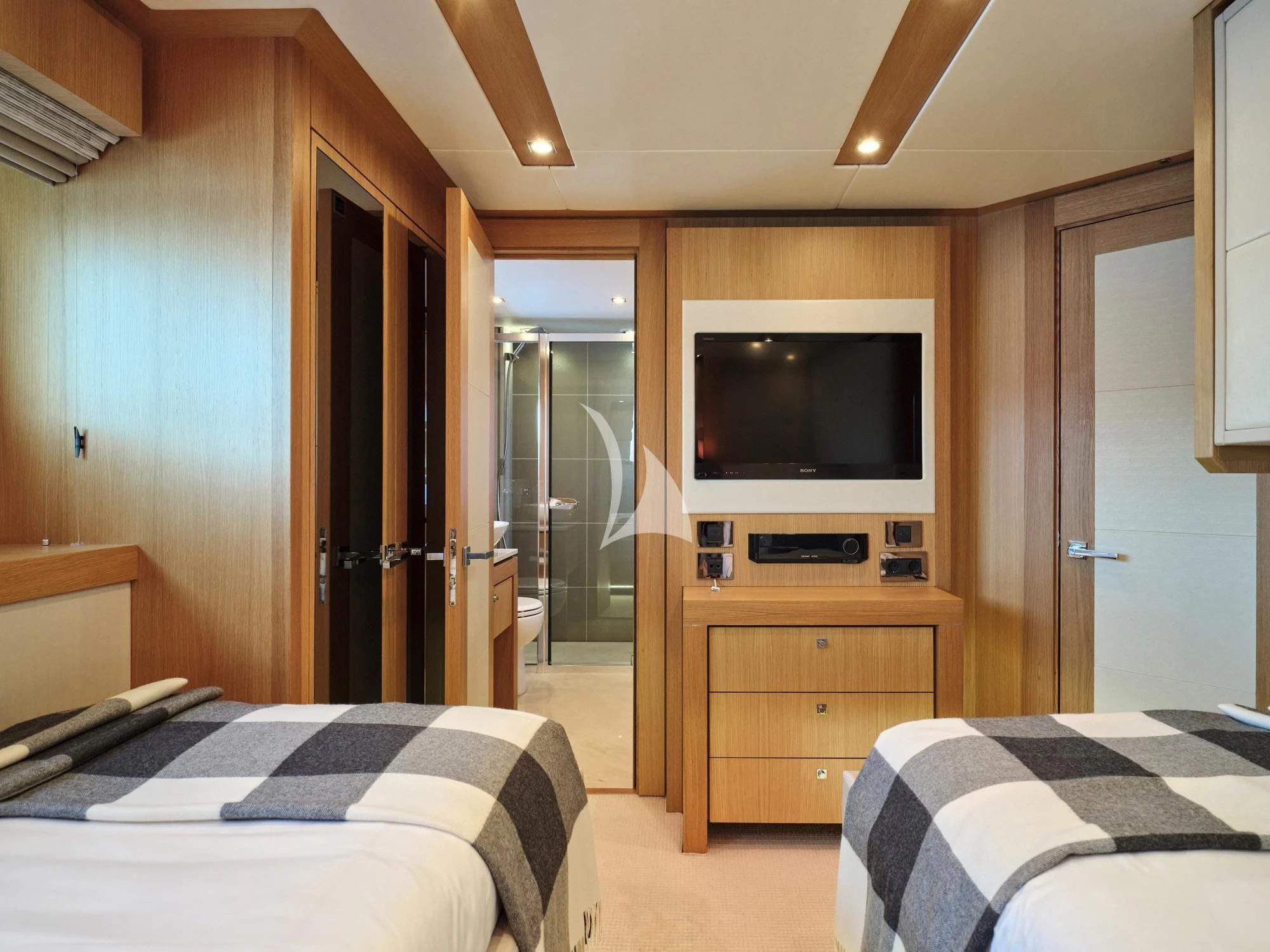 a bedroom with a tv and a bed aboard MAKANI II Yacht for Charter