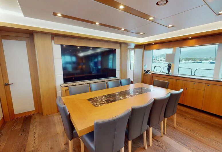 a kitchen with a table and chairs aboard MAKANI II Yacht for Charter