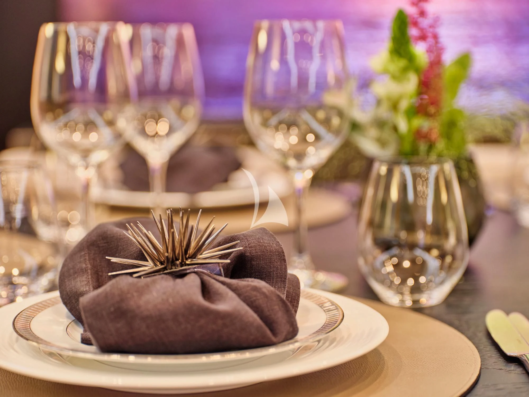 a plate of food and glasses aboard MAKANI II Yacht for Charter