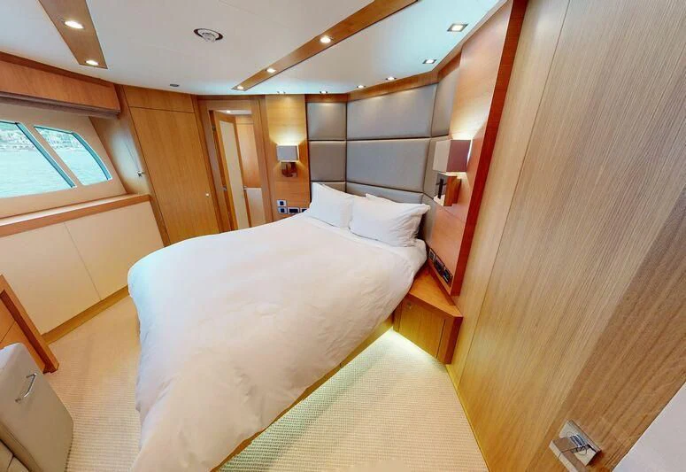 a room with a bed and a closet aboard MAKANI II Yacht for Charter