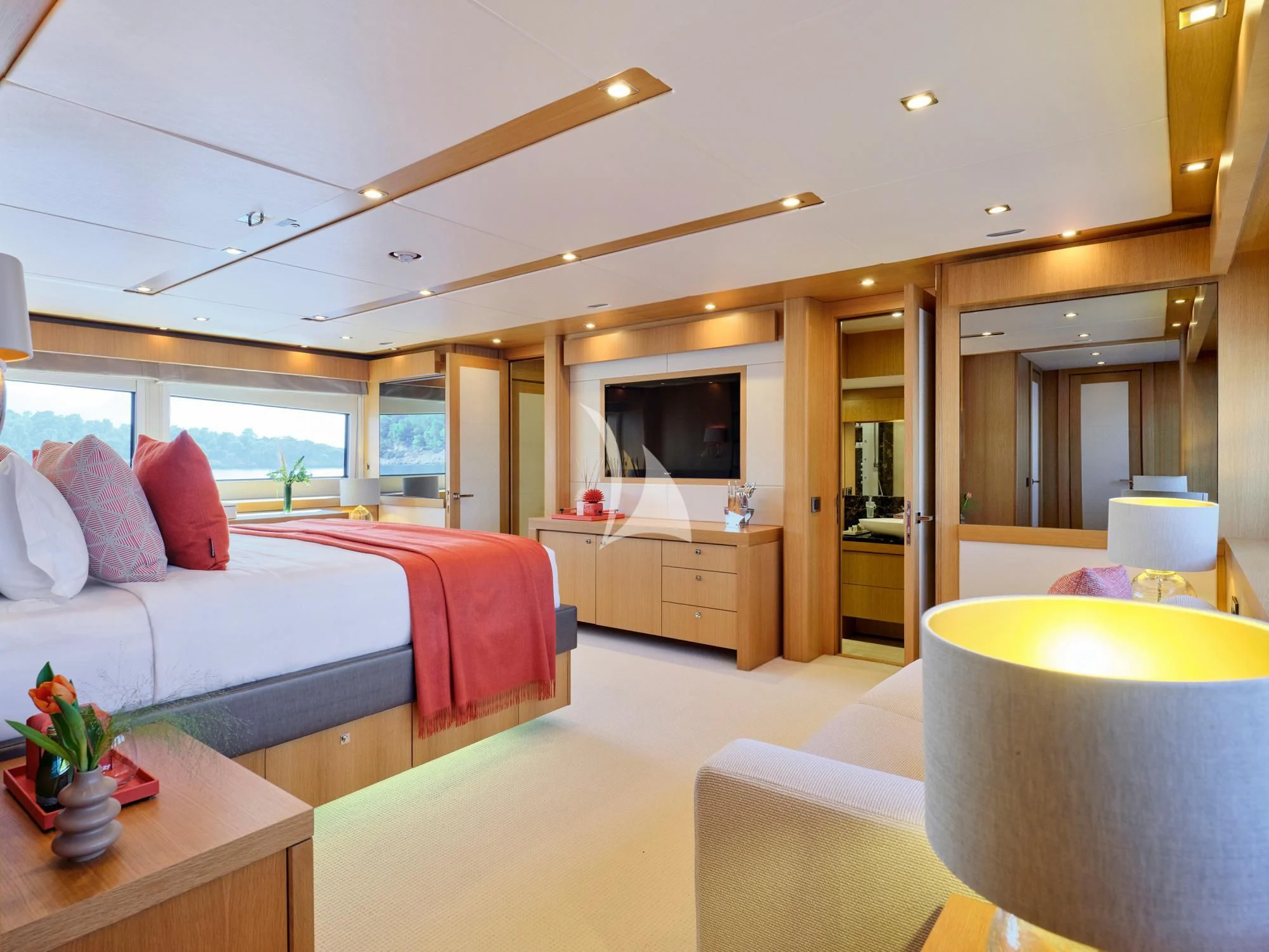 a bedroom with a bed and a television aboard MAKANI II Yacht for Charter