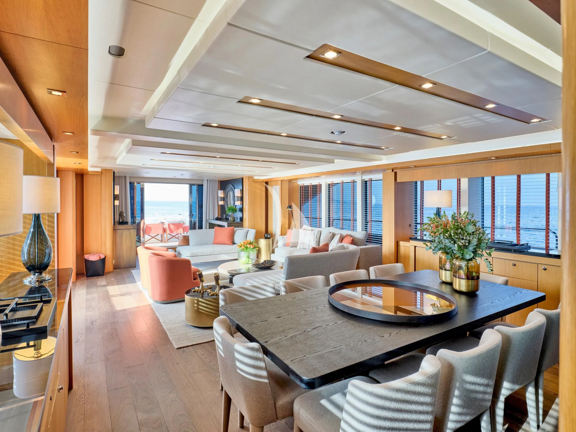 a large living room with a large table and chairs aboard MAKANI II Yacht for Charter