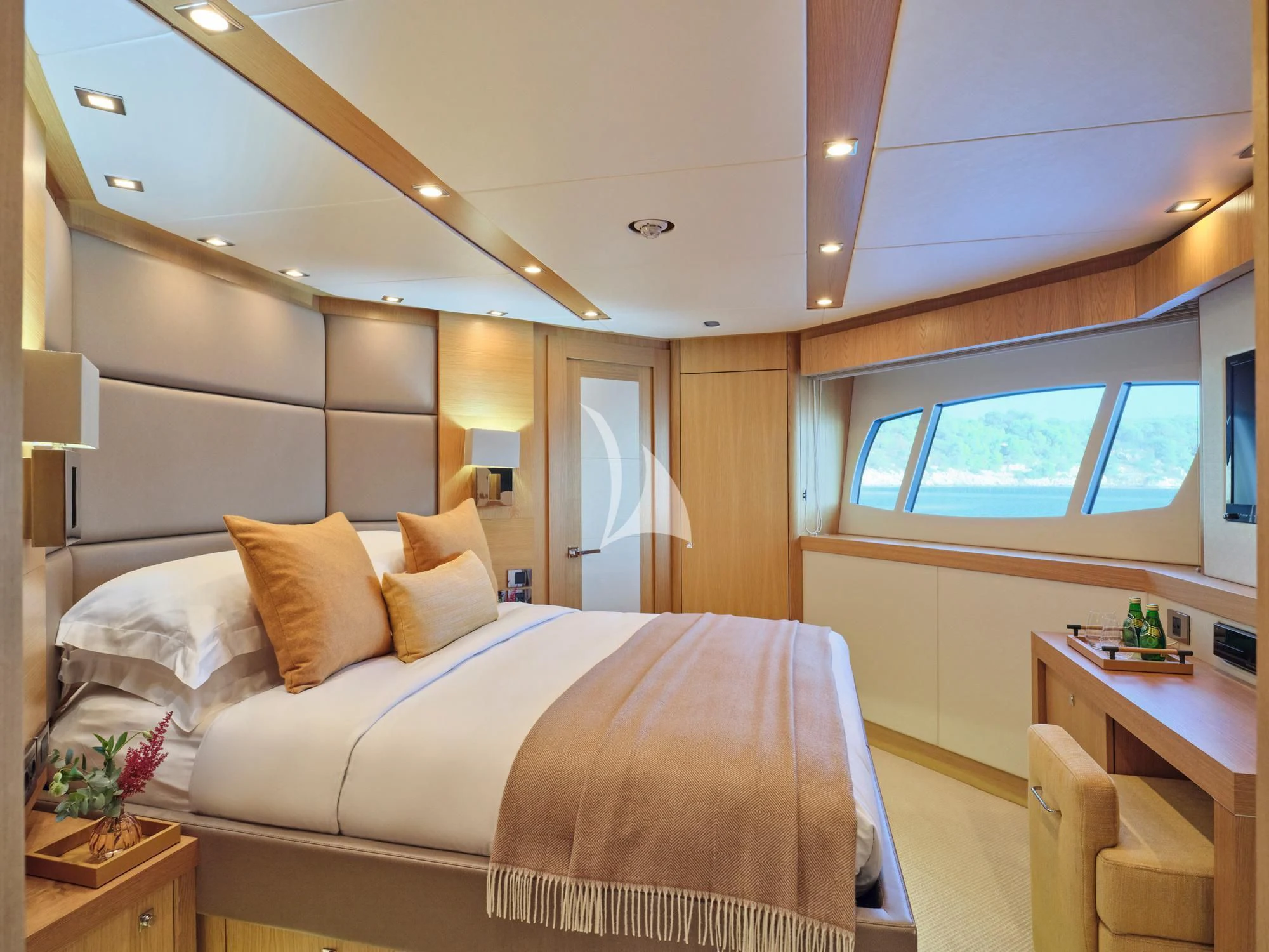 a bedroom with a bed and a desk aboard MAKANI II Yacht for Charter